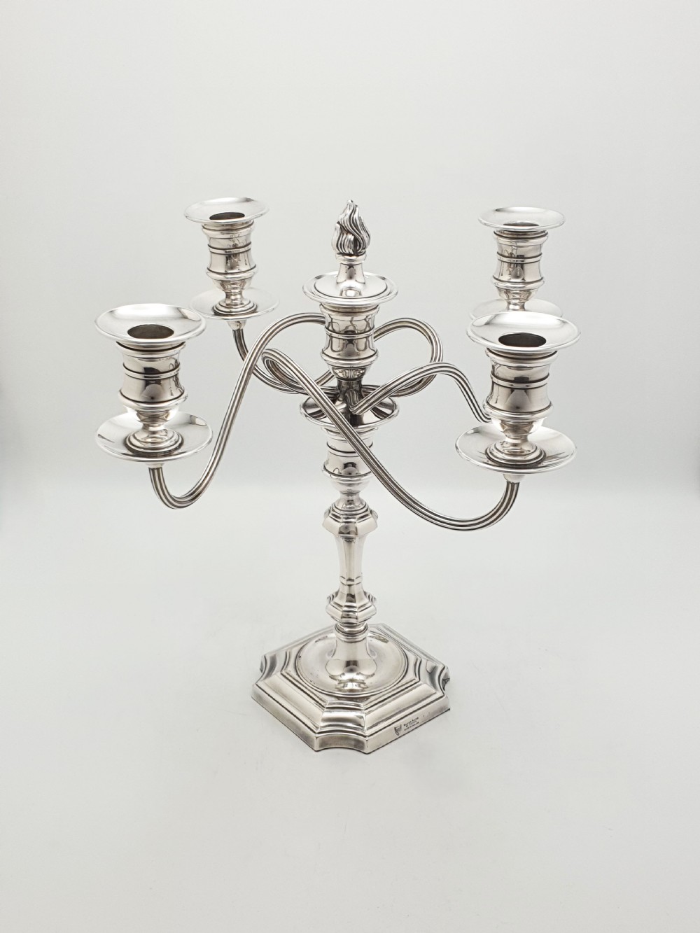 An Edwardian silver-plated five-light candelabrum featuring curved scrolling arms, urn-form sconces, a removable flame finial, and a stepped square base. View III