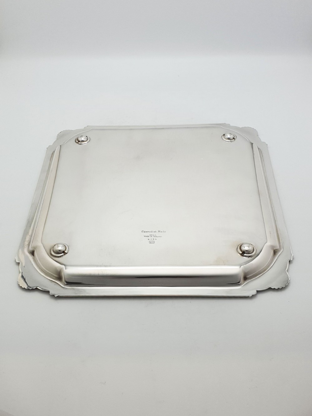 A square silver-plated cocktail tray featuring moulded shell motifs at the four corners and a gadrooned rim border. View IV