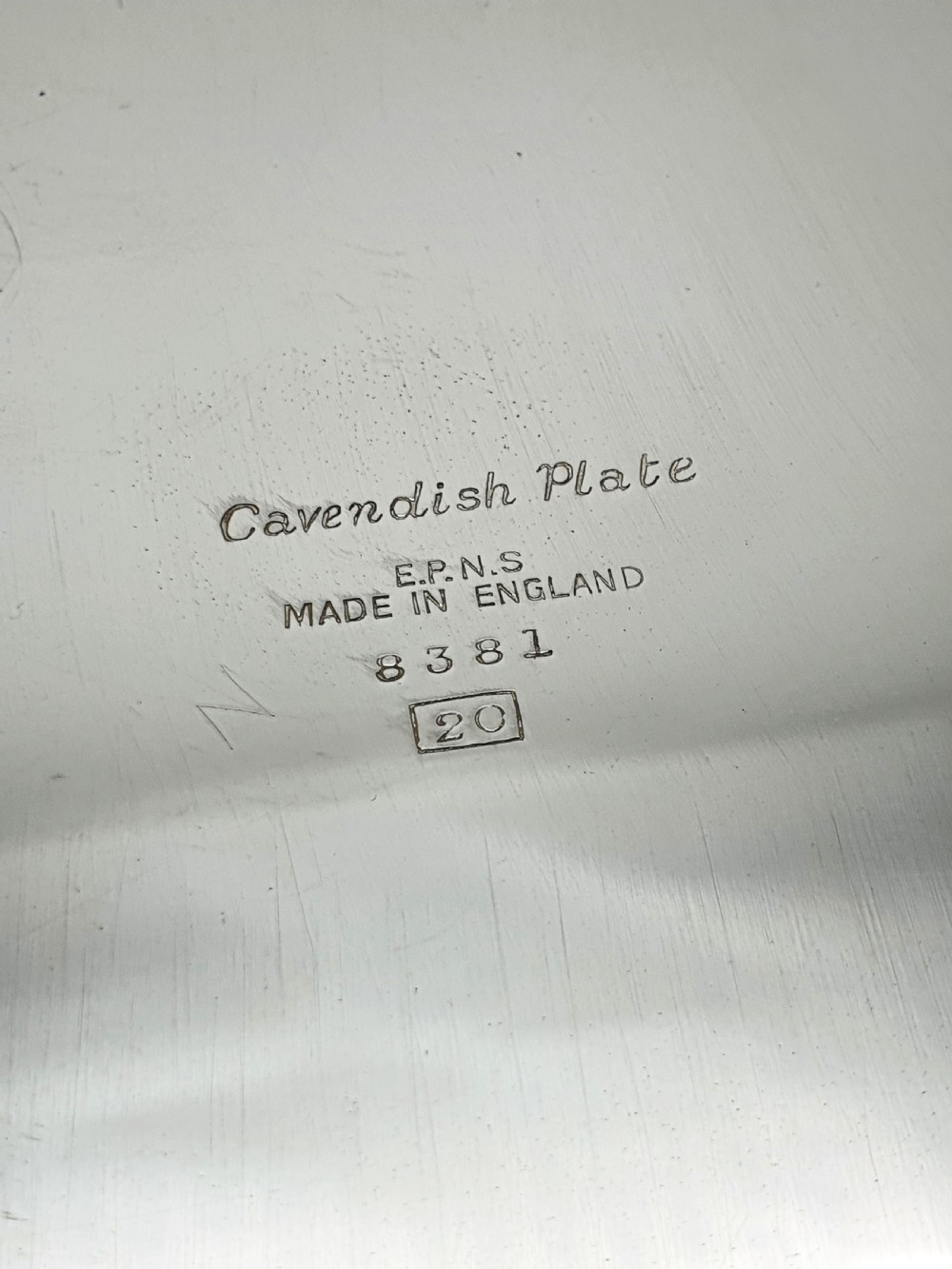 A square silver-plated cocktail tray featuring moulded shell motifs at the four corners and a gadrooned rim border. View V