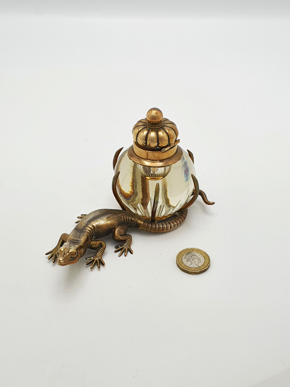 An antique Victorian brass inkstand featuring a cast lizard wrapped around a clear spherical glass inkwell with a crown-shaped hinged lid. View VII