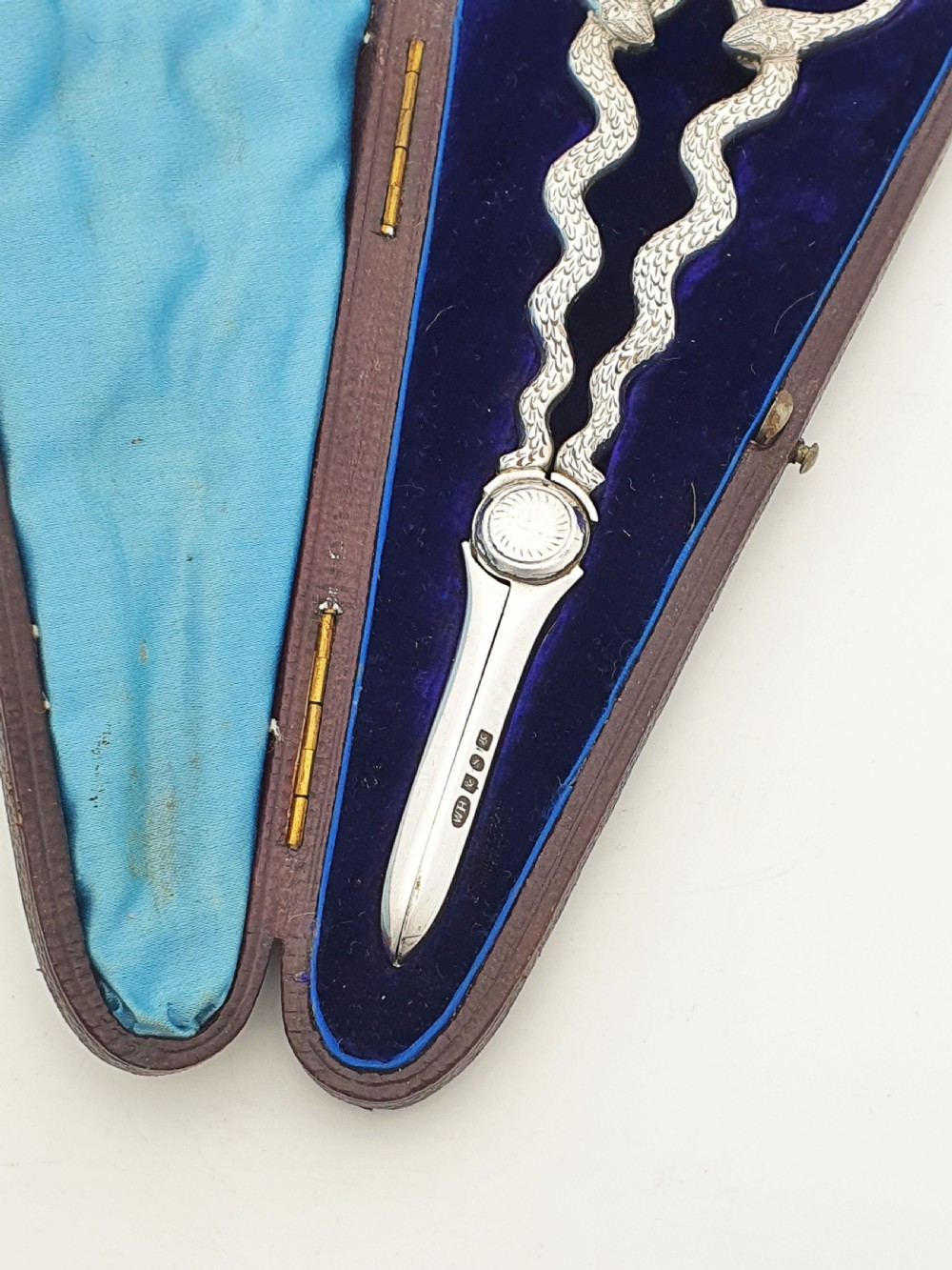 A pair of Victorian silver grape scissors with serpent-shaped handles, presented inside an open velvet-lined protective case. View IV