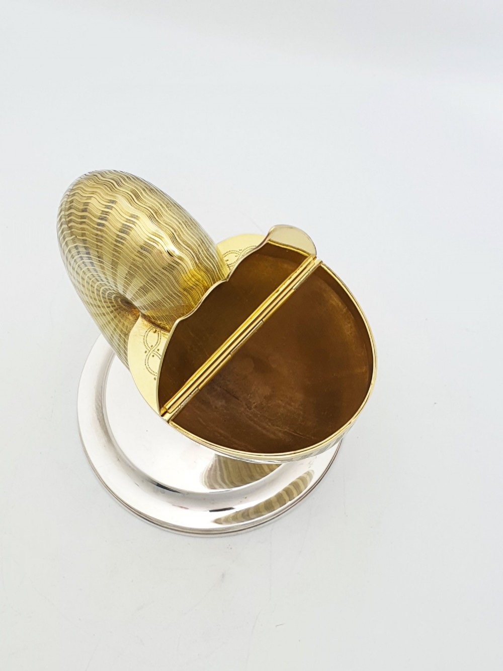 A Victorian silver-plated and gilt metal spoon warmer designed in the form of a nautilus shell on a pedestal base. View III