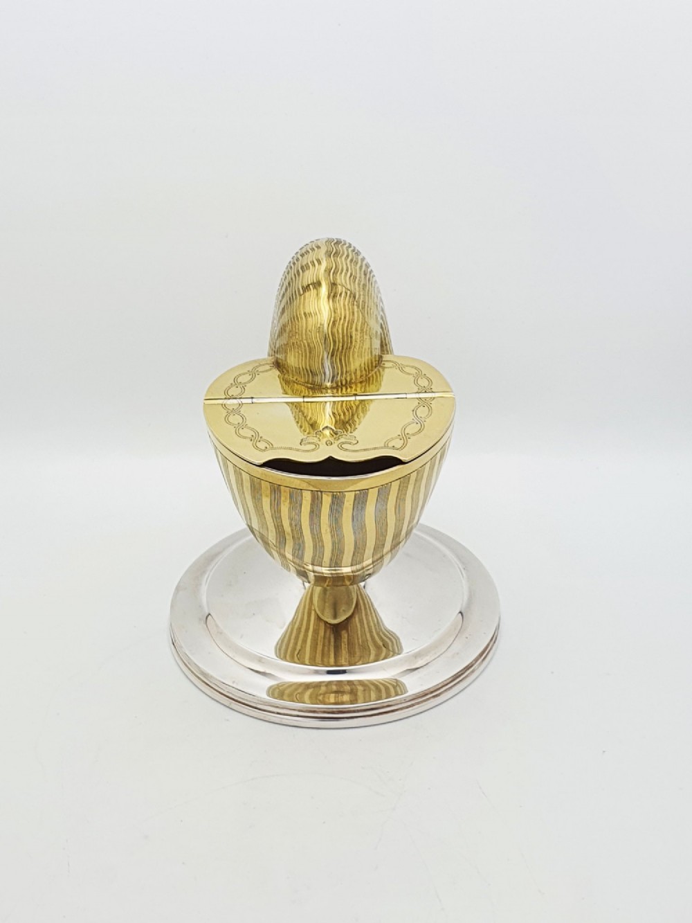 A Victorian silver-plated and gilt metal spoon warmer designed in the form of a nautilus shell on a pedestal base. View VII