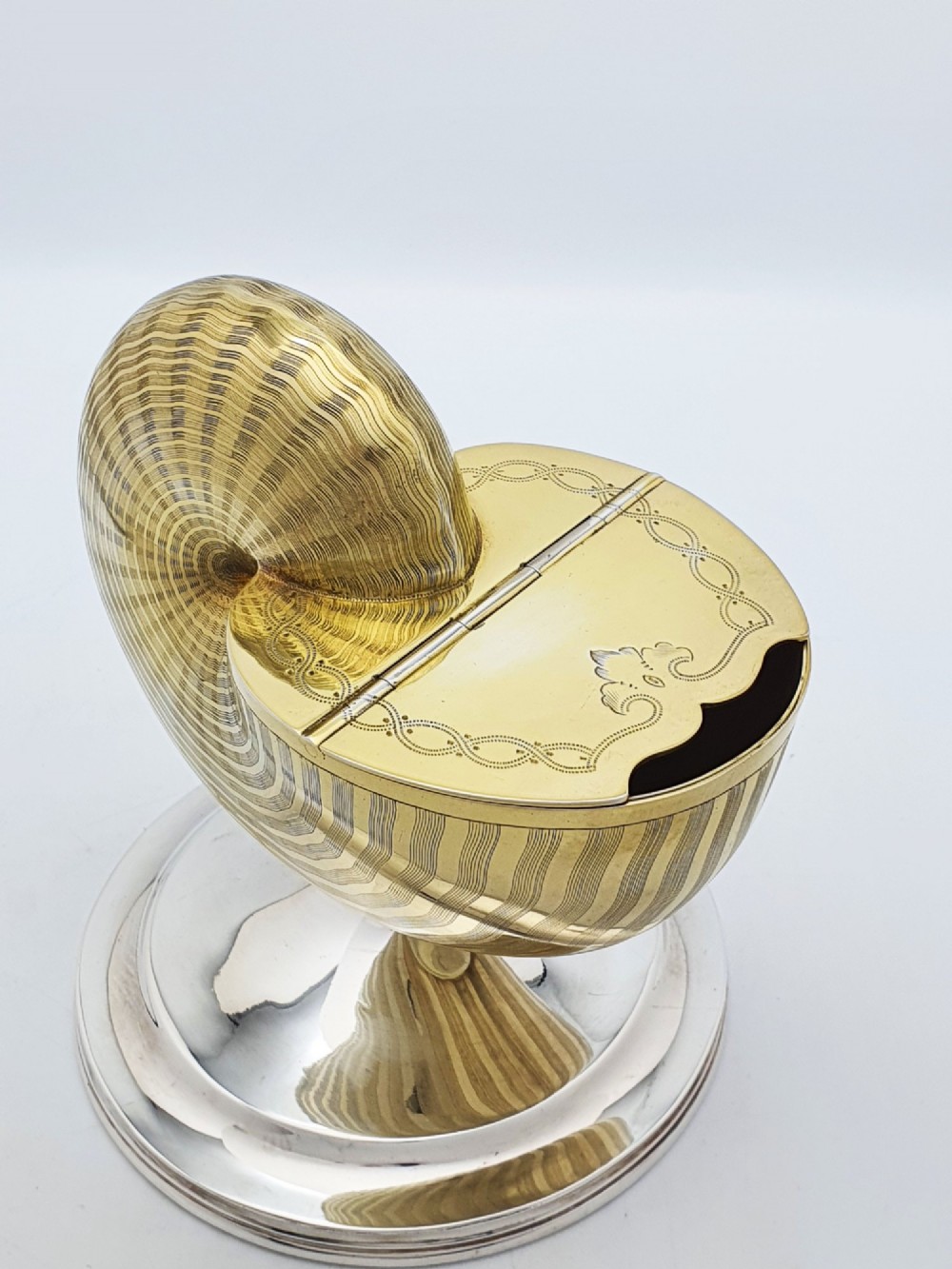 A Victorian silver-plated and gilt metal spoon warmer designed in the form of a nautilus shell on a pedestal base. View VIII