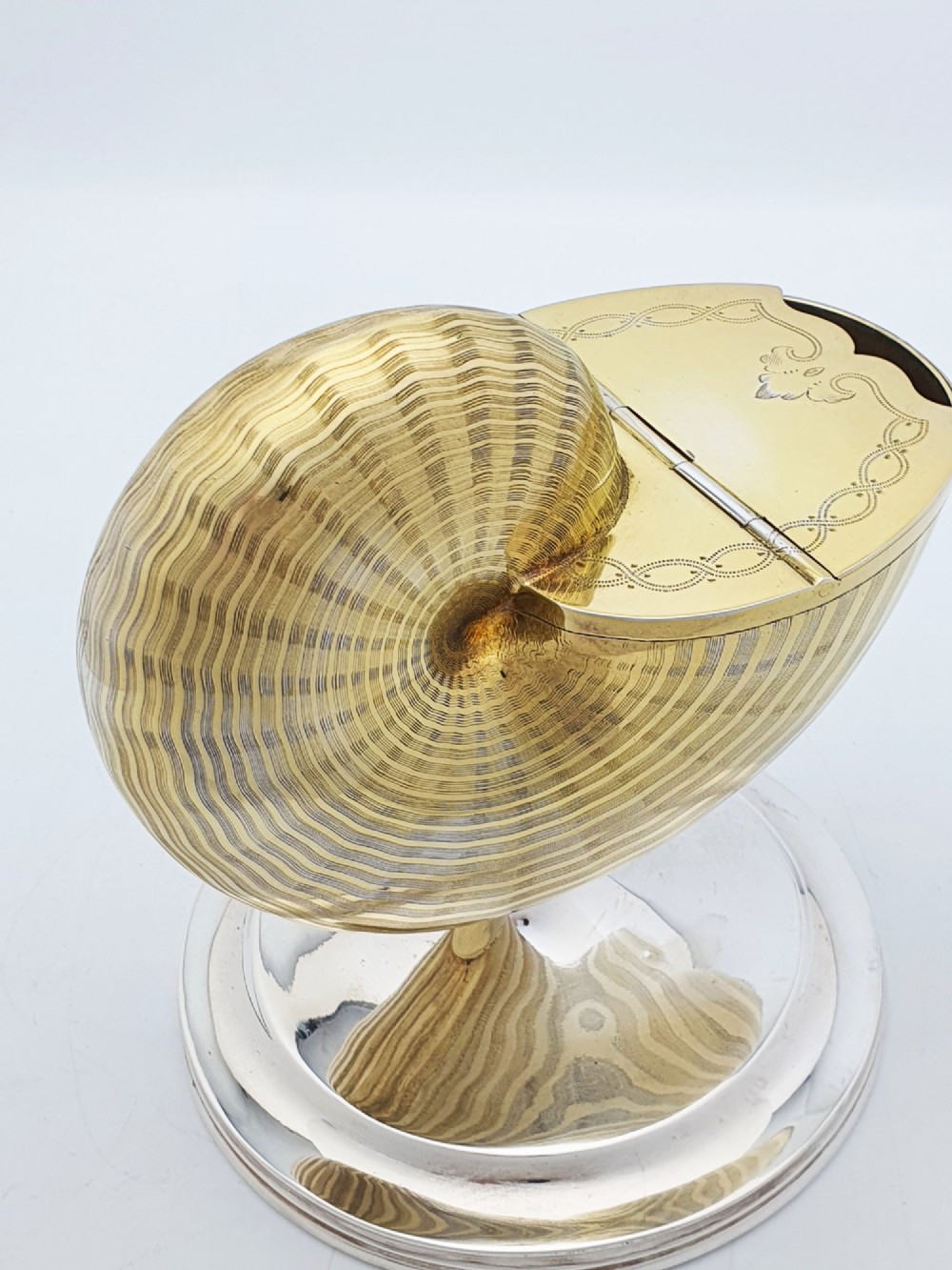 A Victorian silver-plated and gilt metal spoon warmer designed in the form of a nautilus shell on a pedestal base. View IX