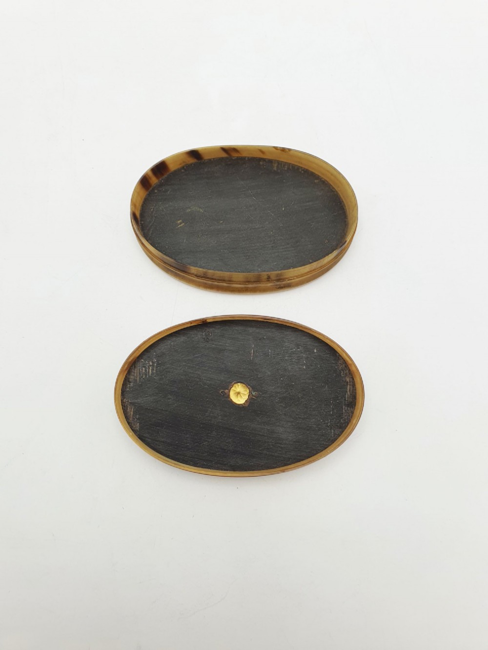 An oval Victorian snuff box made from natural mottled horn featuring a central faceted yellow citrine gem mounted on the lid. View III