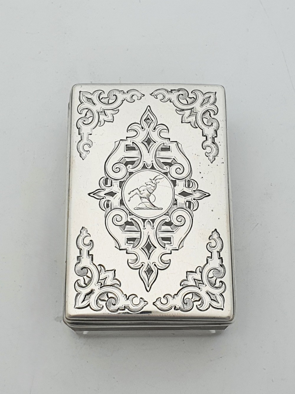 A rectangular cut glass trinket box featuring a sterling silver lid engraved with elaborate scrollwork and a central stag crest. View II