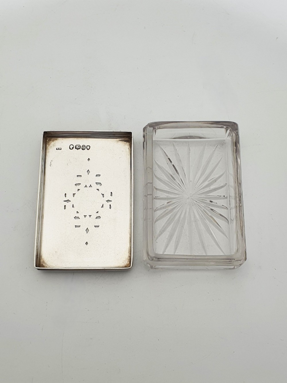 A rectangular cut glass trinket box featuring a sterling silver lid engraved with elaborate scrollwork and a central stag crest. View III