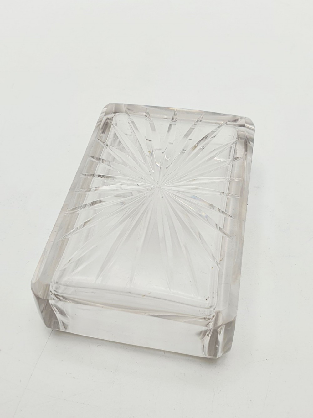 A rectangular cut glass trinket box featuring a sterling silver lid engraved with elaborate scrollwork and a central stag crest. View V