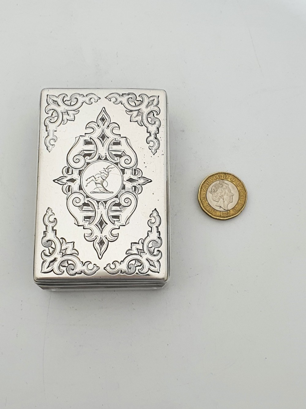 A rectangular cut glass trinket box featuring a sterling silver lid engraved with elaborate scrollwork and a central stag crest. View VI