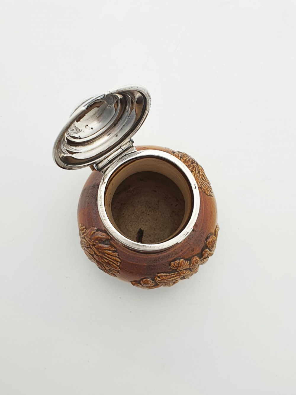 A small salt-glazed brown and beige stoneware jug featuring relief motifs and a hallmarked sterling silver hinged lid and collar. View IX