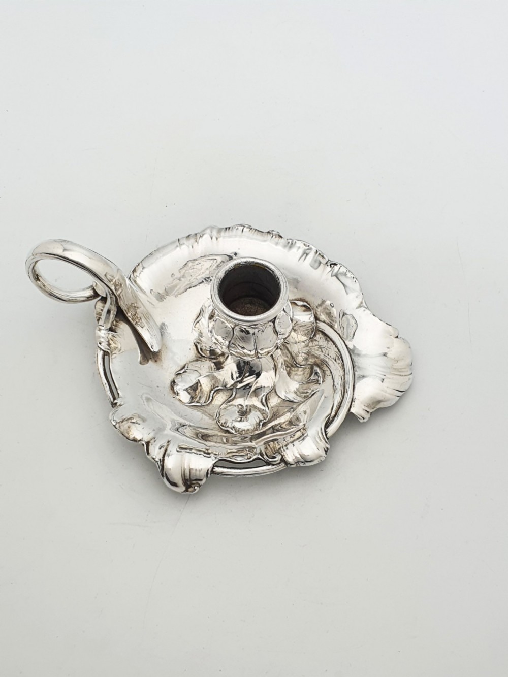 An Art Nouveau silver-plated chamberstick featuring a leaf-form tray base, organic sconce nozzle, and a looped handle. View II