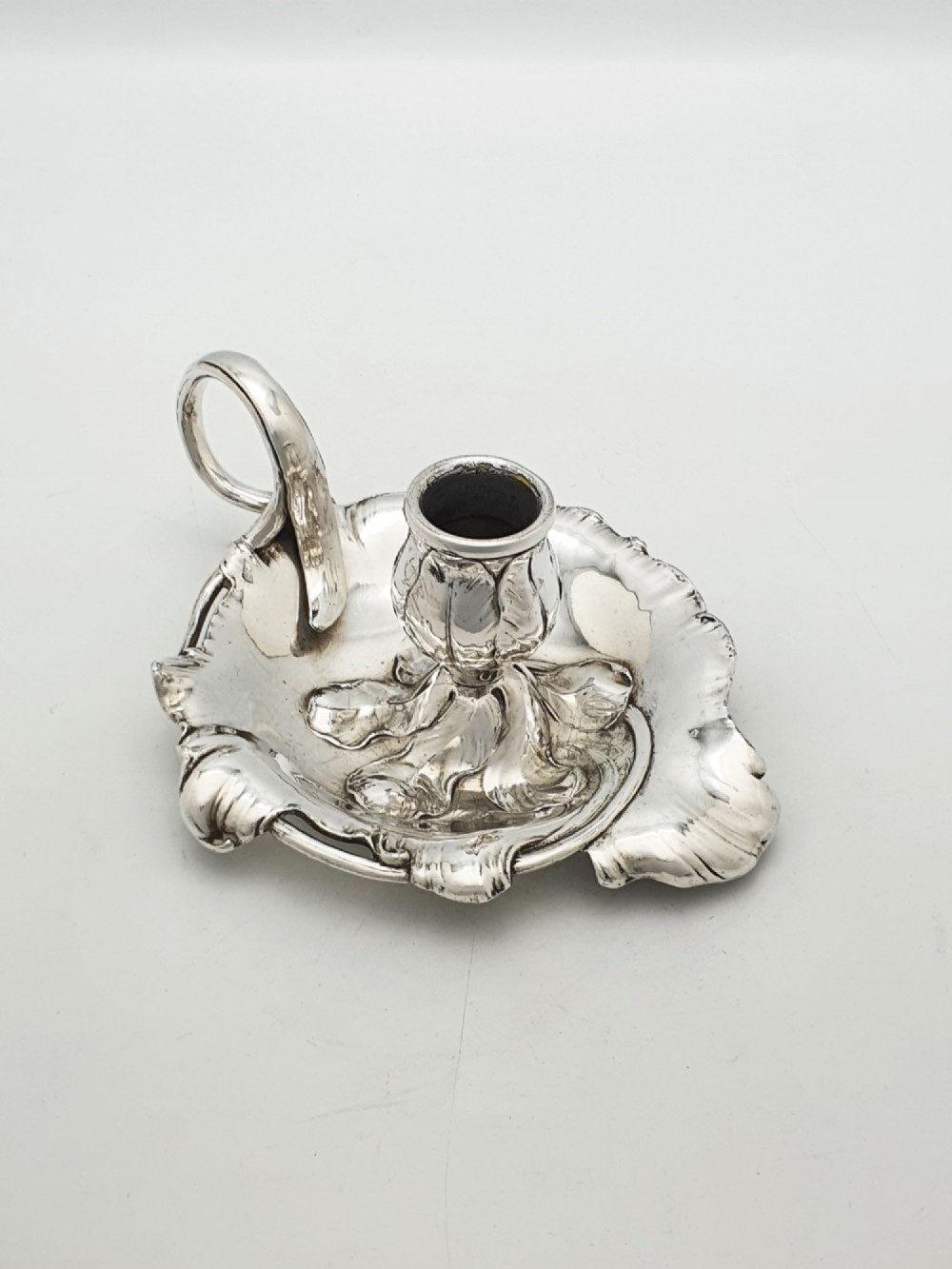 An Art Nouveau silver-plated chamberstick featuring a leaf-form tray base, organic sconce nozzle, and a looped handle. View III