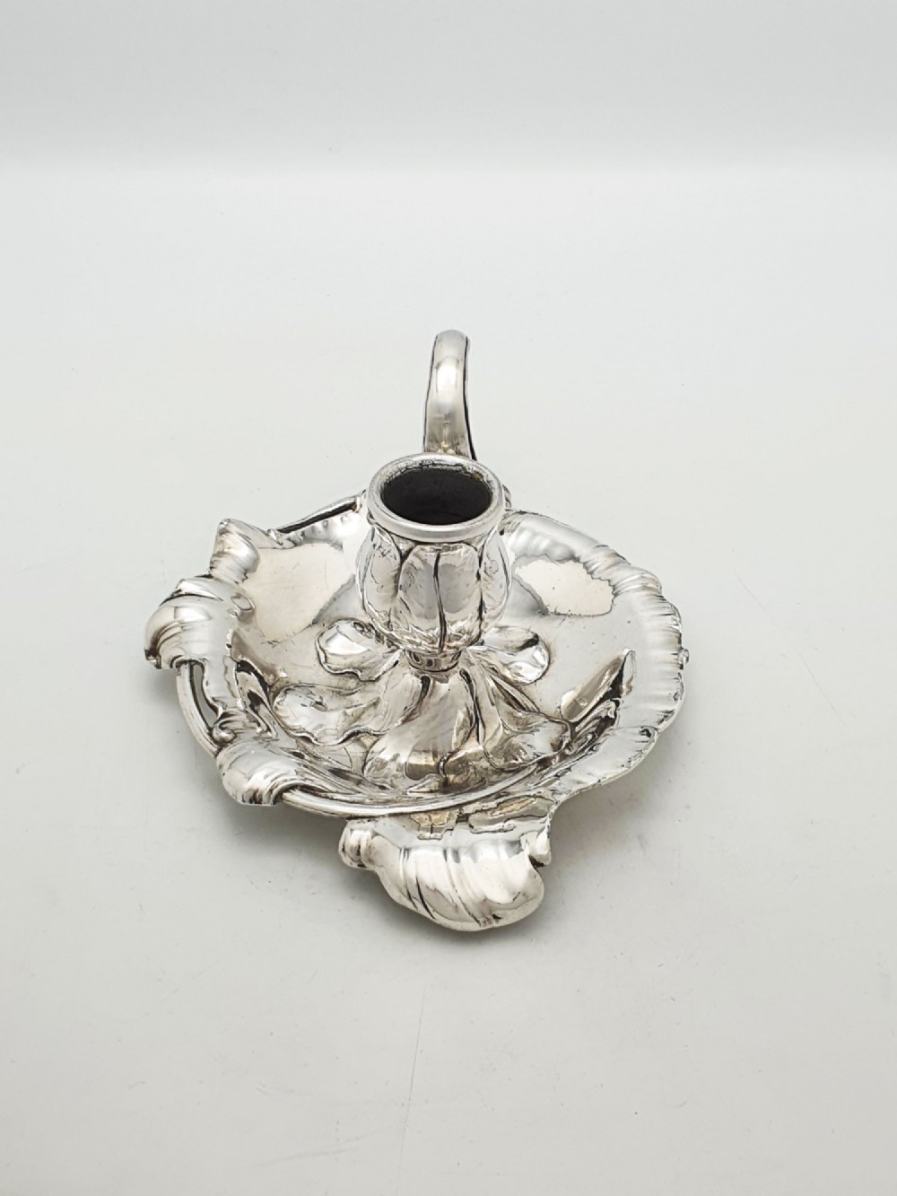 An Art Nouveau silver-plated chamberstick featuring a leaf-form tray base, organic sconce nozzle, and a looped handle. View IV