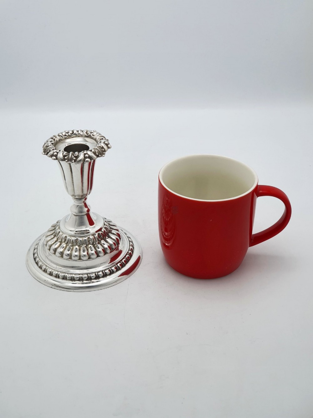 A pair of antique Edwardian low silver-plated candlesticks featuring fluted sockets and gadrooned circular bases. View VIII