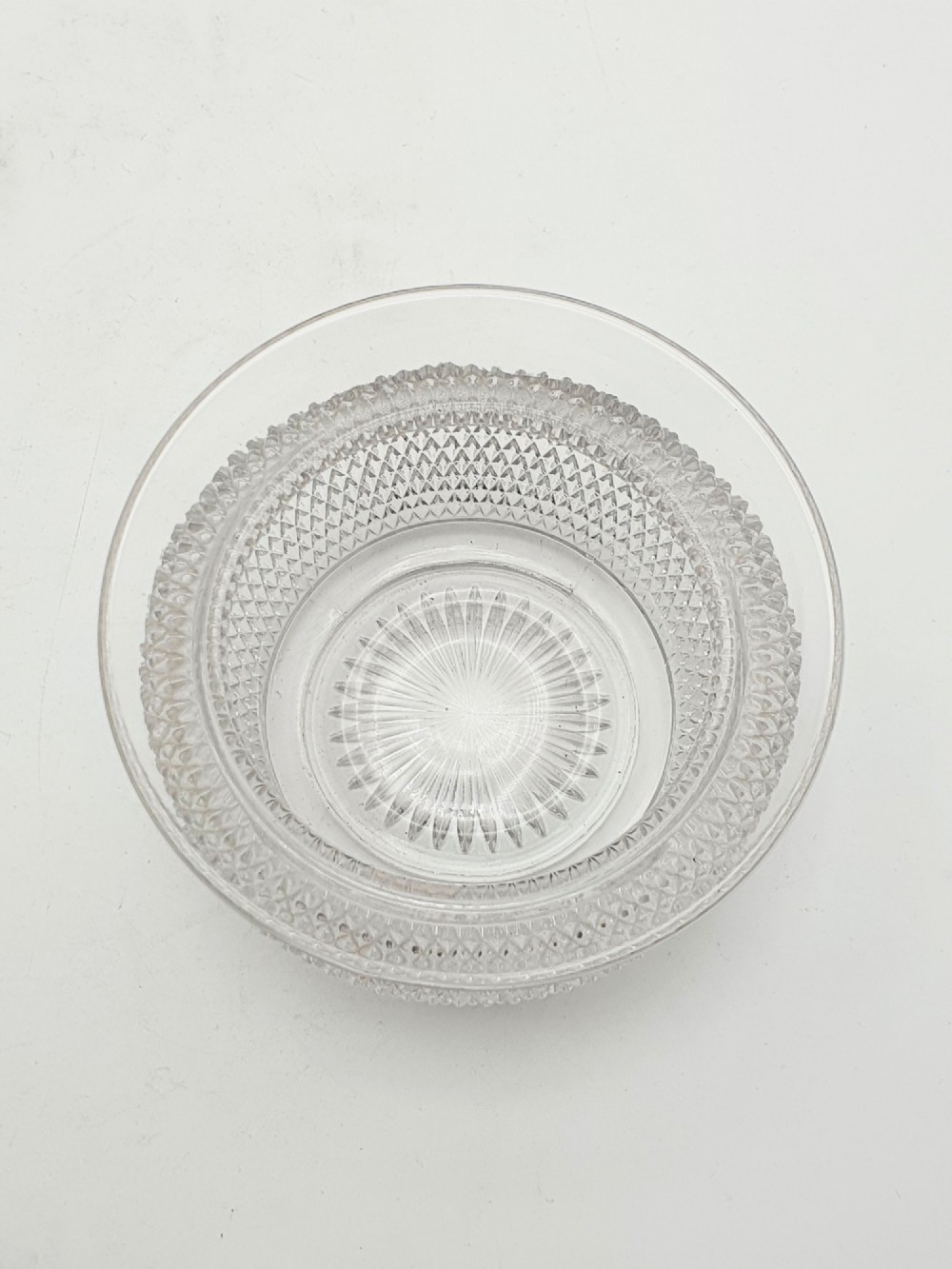 A silver-plated condiment stand featuring a central looped handle, ball feet, and two clear diamond-patterned glass bowls. View IV