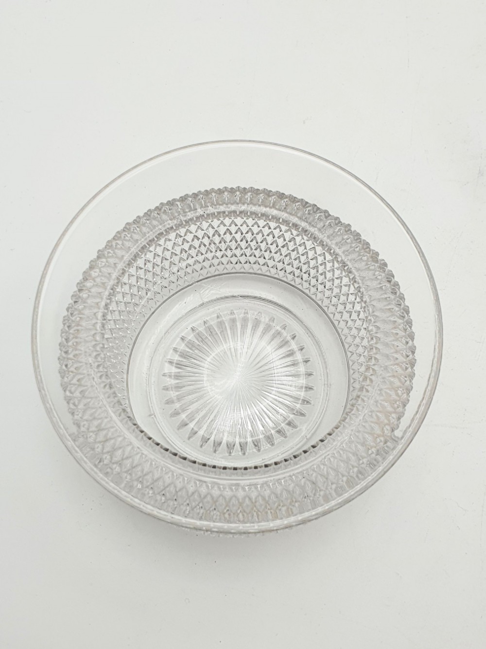 A silver-plated condiment stand featuring a central looped handle, ball feet, and two clear diamond-patterned glass bowls. View V