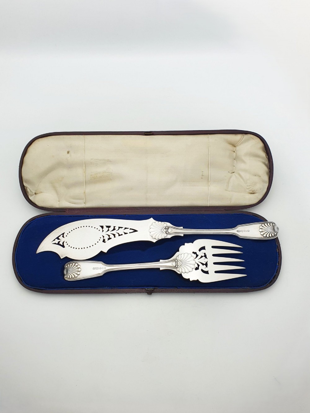 An antique Victorian silver-plated fish serving set with an engraved knife and fork presented in a fitted satin and velvet lined case. View V