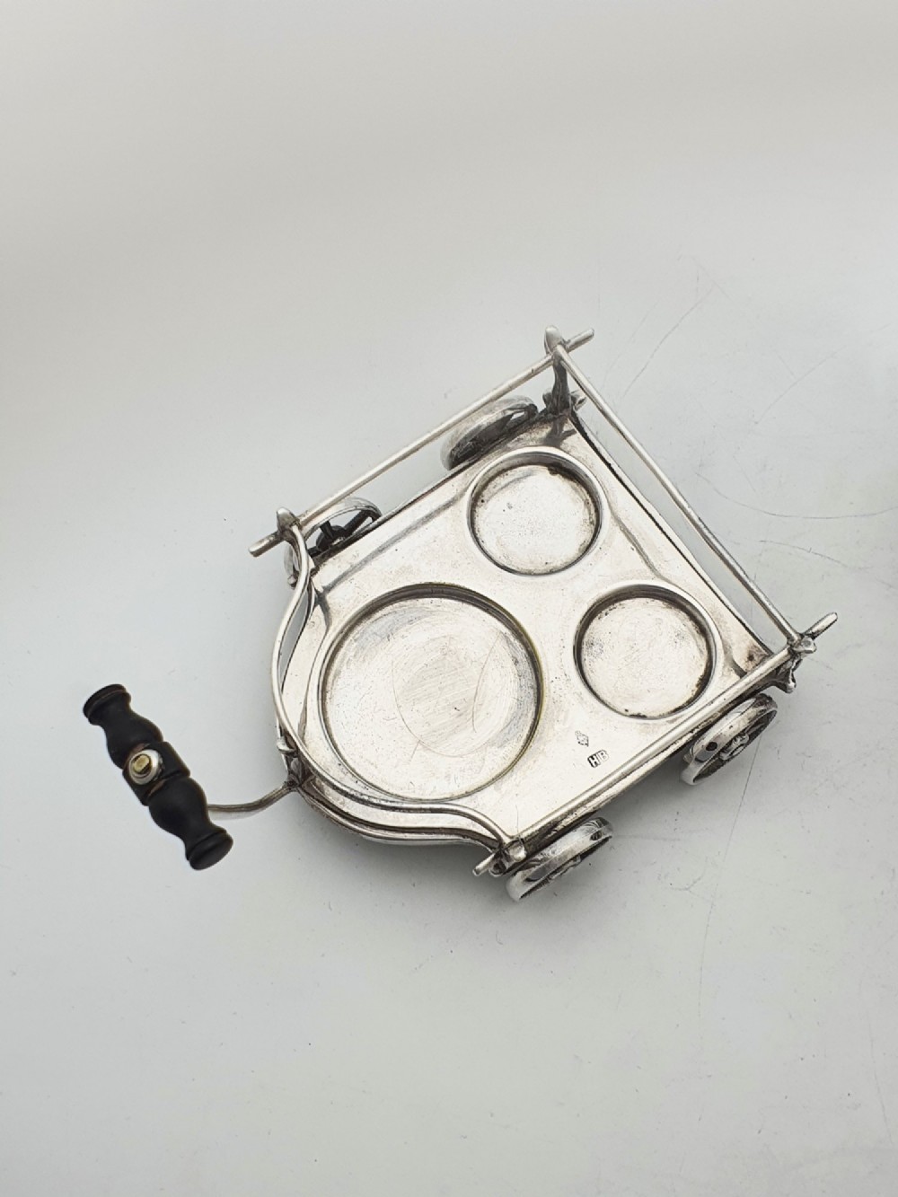 An antique Victorian silver-plated condiment set crafted as a miniature four-wheeled trolley holding three oak barrel-shaped containers. View VII