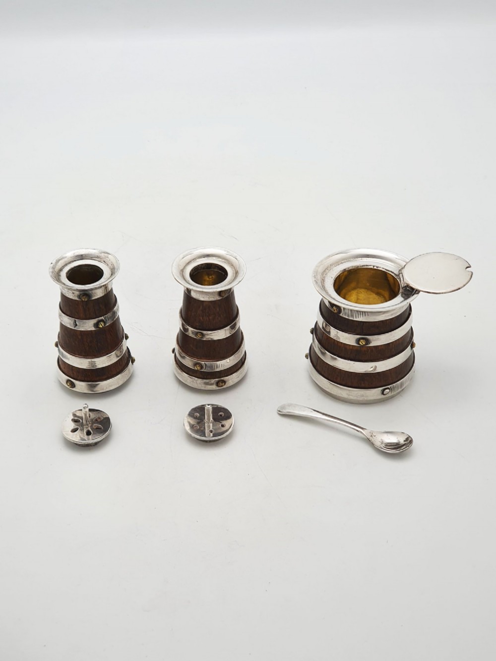 An antique Victorian silver-plated condiment set crafted as a miniature four-wheeled trolley holding three oak barrel-shaped containers. View IX