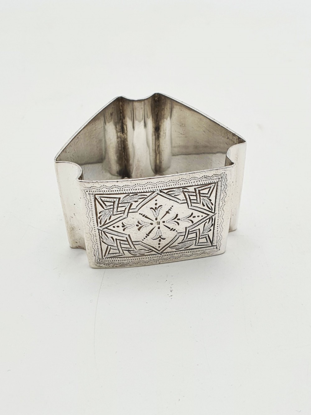 A set of six Edwardian silver-plated napkin rings numbered one through six with engraved geometric borders. View III