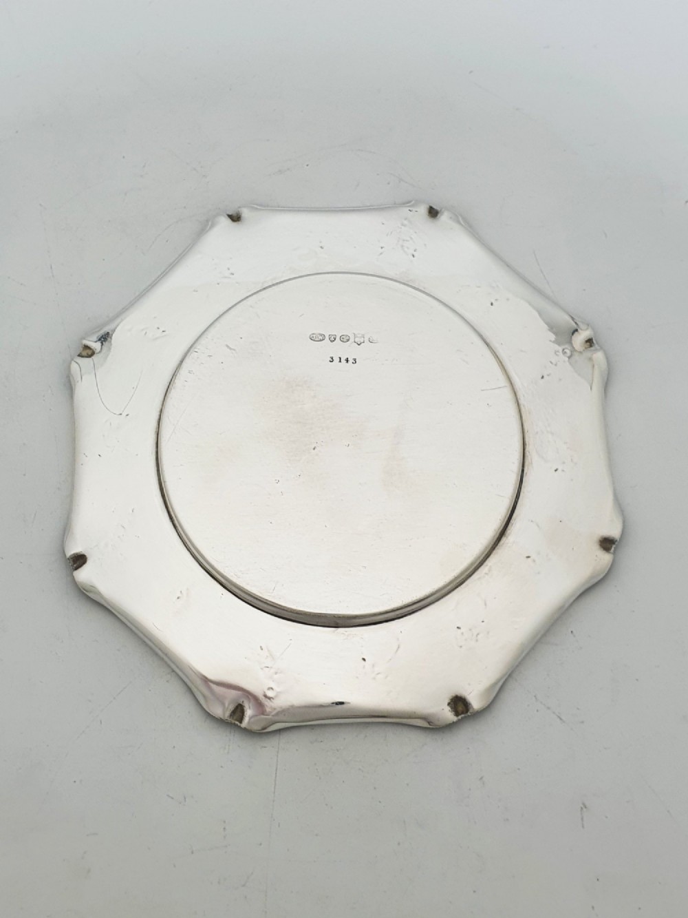 A Victorian silver-plated circular butter dish featuring bright-cut engraving and a lid with a central finial, housing a clear cut-glass liner. View VI