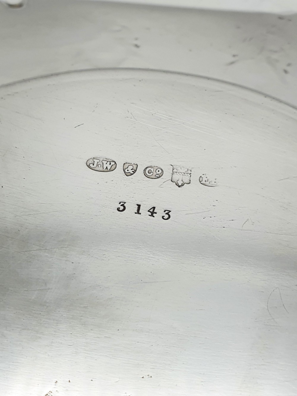 A Victorian silver-plated circular butter dish featuring bright-cut engraving and a lid with a central finial, housing a clear cut-glass liner. View VII