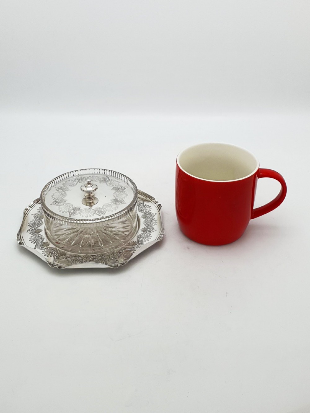 A Victorian silver-plated circular butter dish featuring bright-cut engraving and a lid with a central finial, housing a clear cut-glass liner. View VIII