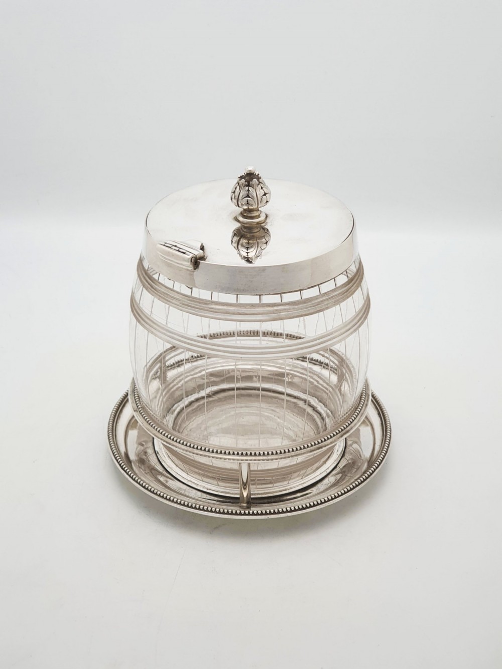 A Victorian cut glass barrel-shaped container with a silver-plated hinged lid and matching stand. View IV