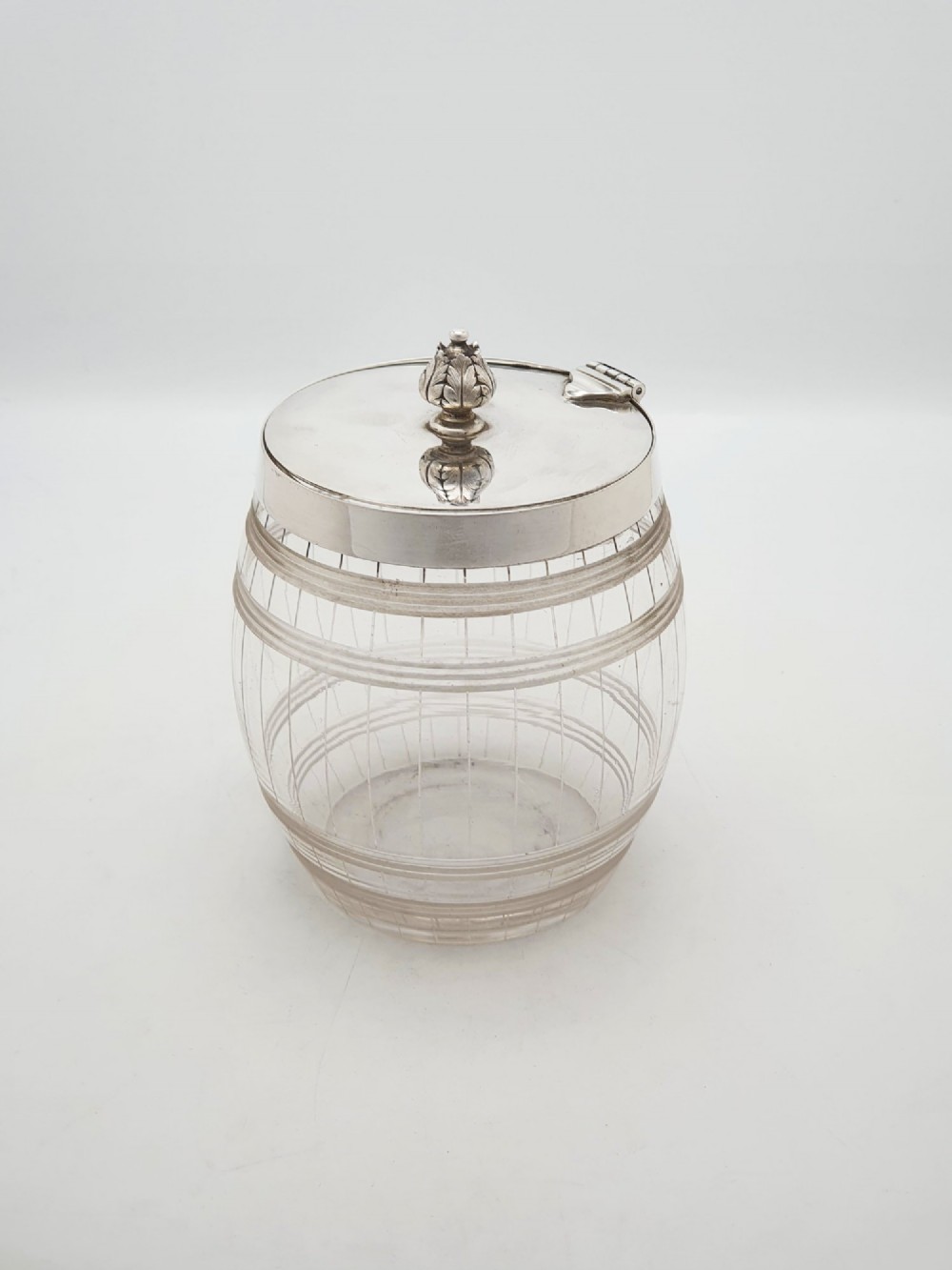 A Victorian cut glass barrel-shaped container with a silver-plated hinged lid and matching stand. View VI