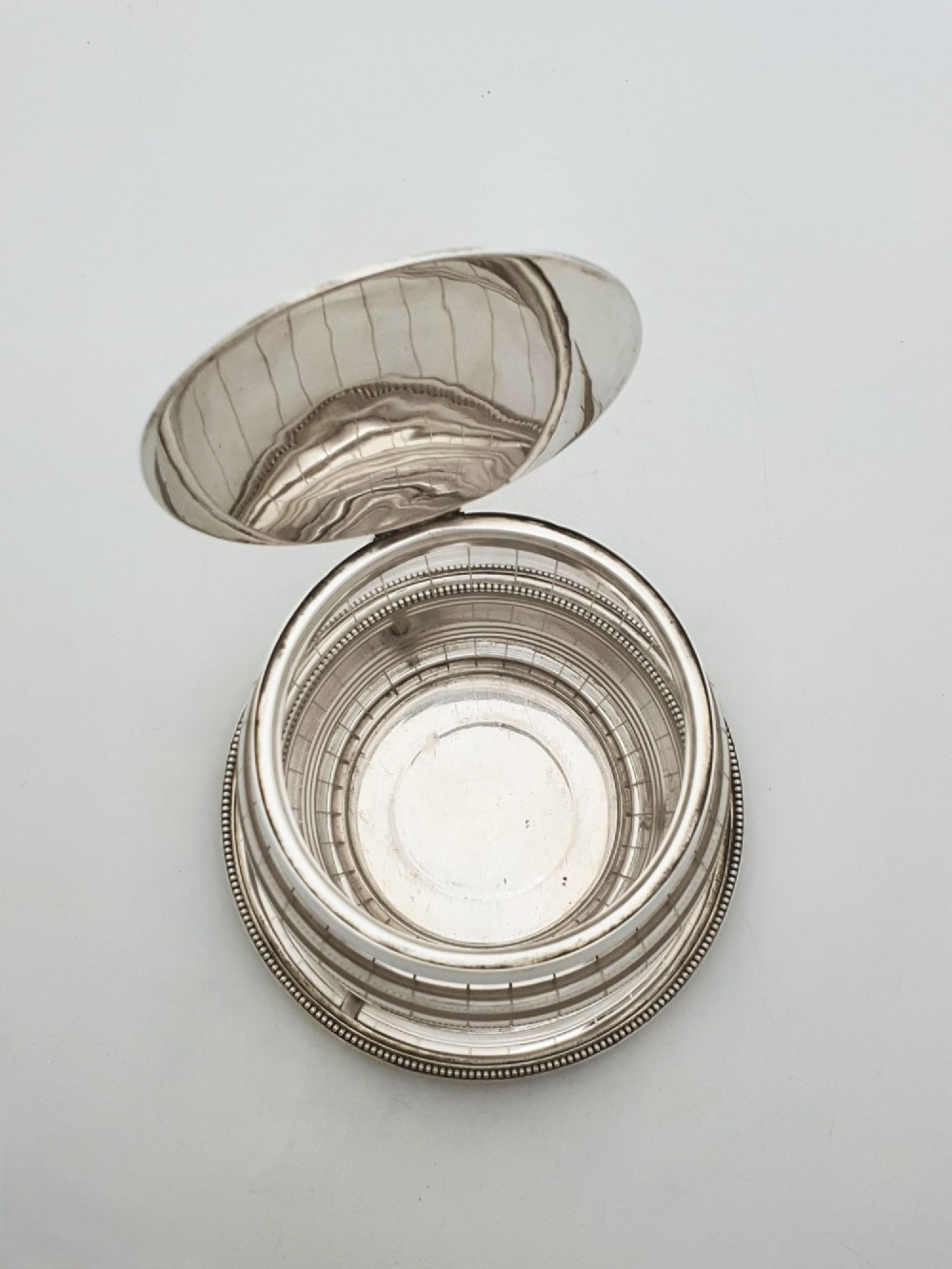 A Victorian cut glass barrel-shaped container with a silver-plated hinged lid and matching stand. View X