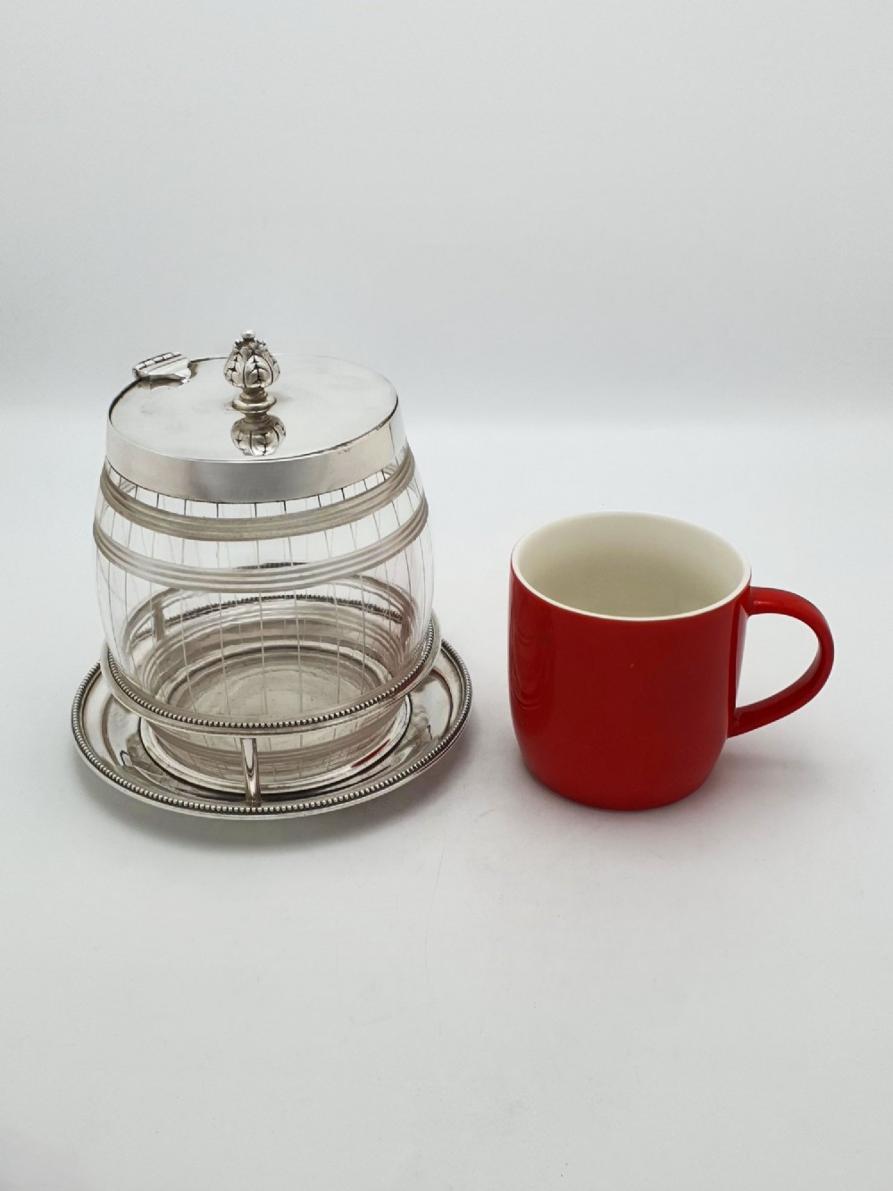 A Victorian cut glass barrel-shaped container with a silver-plated hinged lid and matching stand. View XI