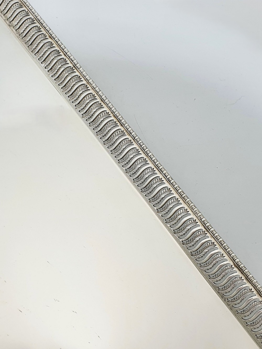 An elongated rectangular silver-plated serving tray featuring a pierced wavy border and leaf-motif end handles. View IV