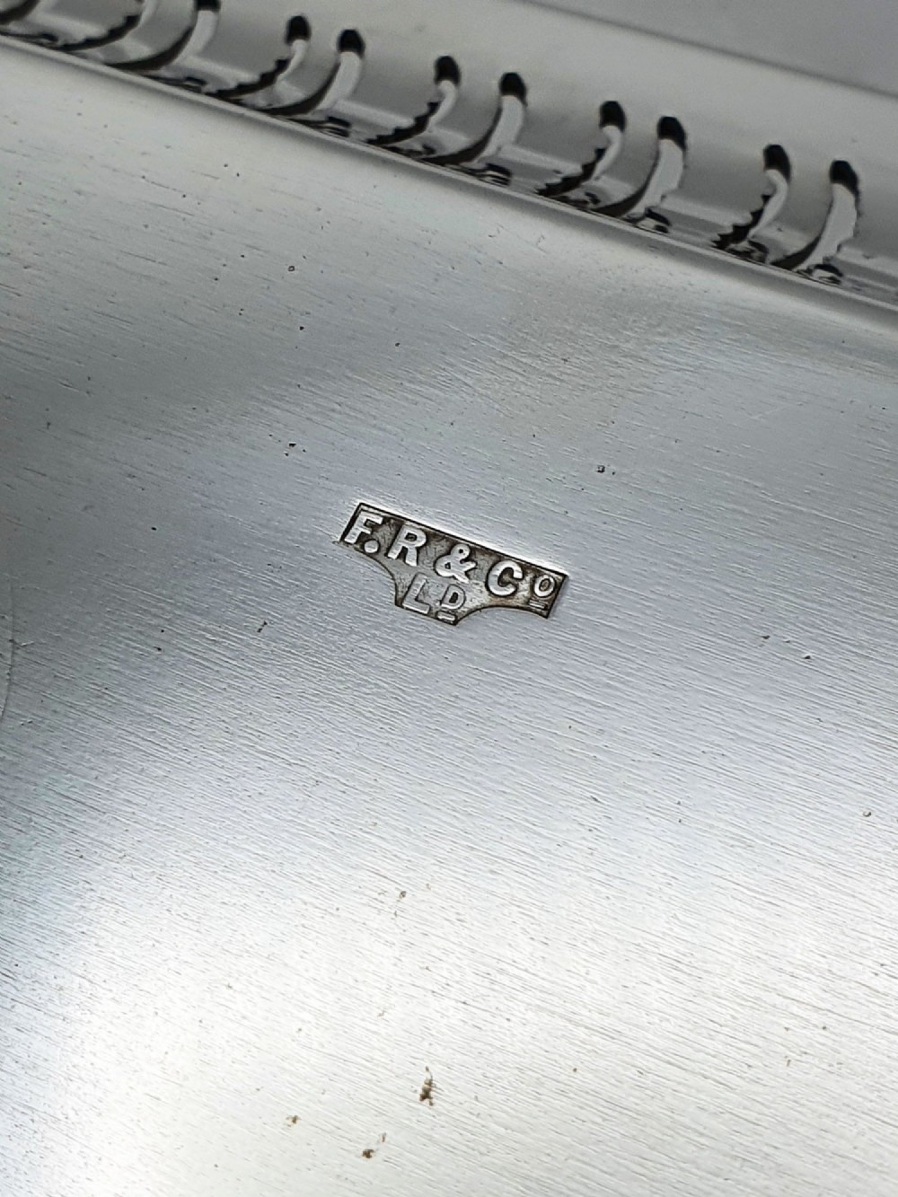 An elongated rectangular silver-plated serving tray featuring a pierced wavy border and leaf-motif end handles. View VI