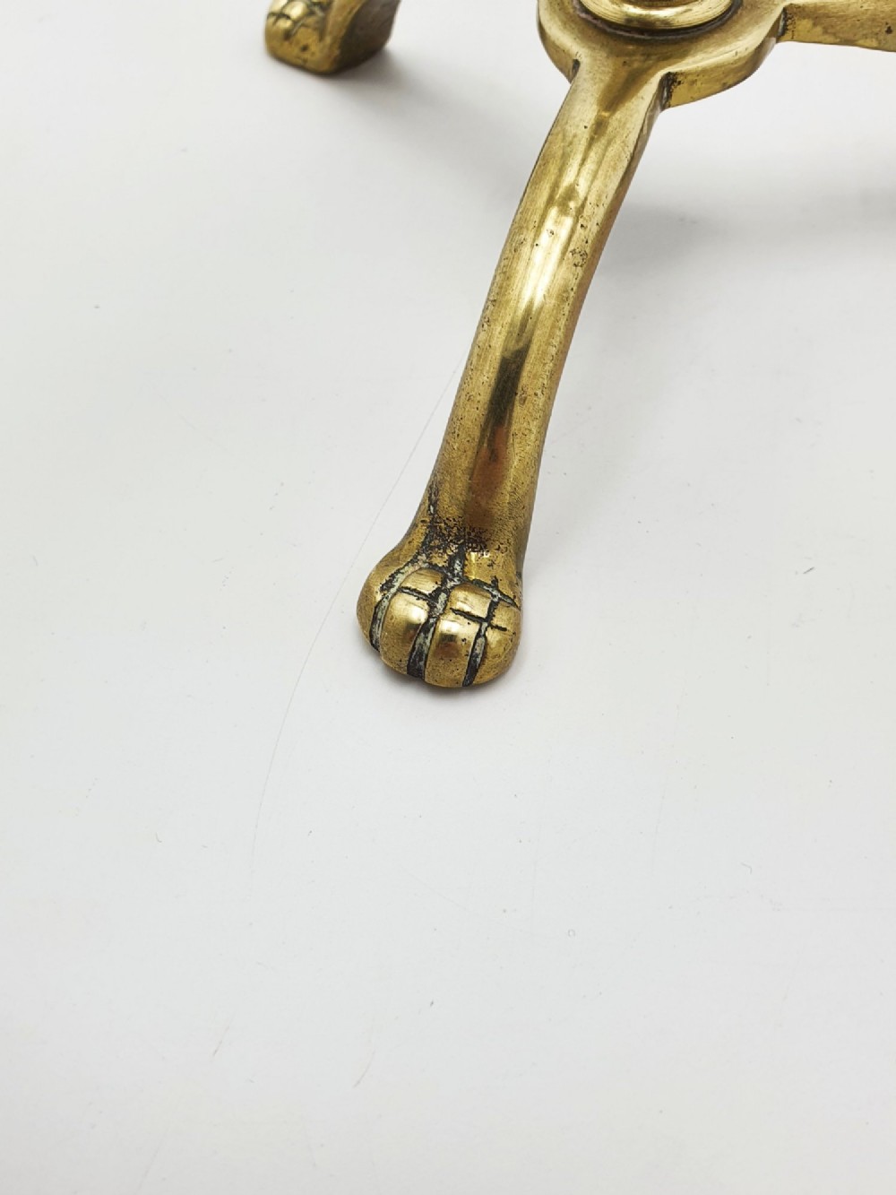 A pair of antique brass four-light adjustable candelabras featuring turned central shafts, tripod feet, and finials. View IV