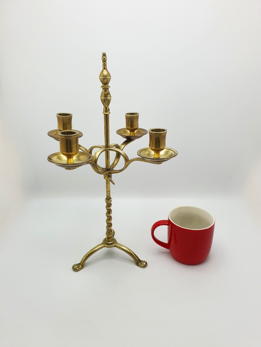 A pair of antique brass four-light adjustable candelabras featuring turned central shafts, tripod feet, and finials. View IX