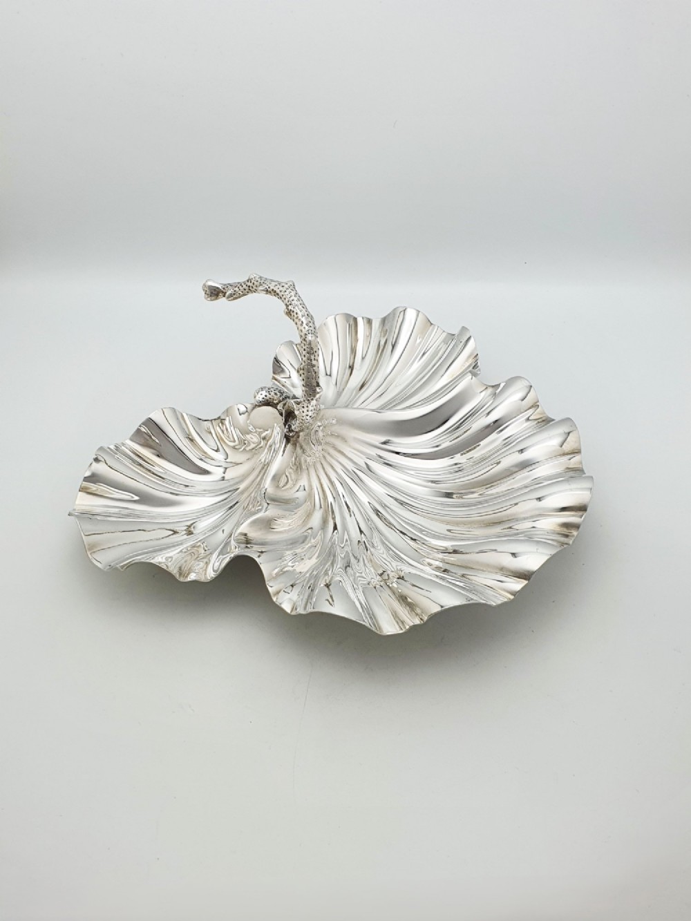 A Victorian silver-plated dish featuring two fluted shell-shaped compartments joined by a central handle modelled as textured coral.