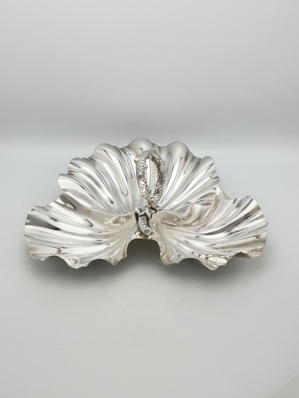 A Victorian silver-plated dish featuring two fluted shell-shaped compartments joined by a central handle modelled as textured coral. View IV