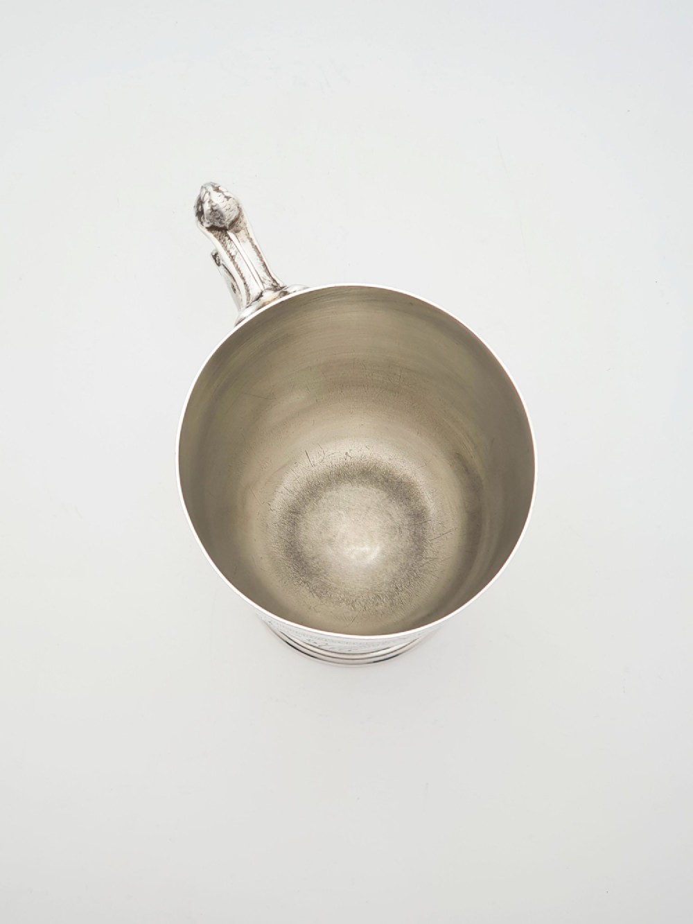 An Edwardian silver-plated tankard with intricate foliate engraving, a fluted pedestal base, and a decorative handle sculpted with an owl motif. View IV