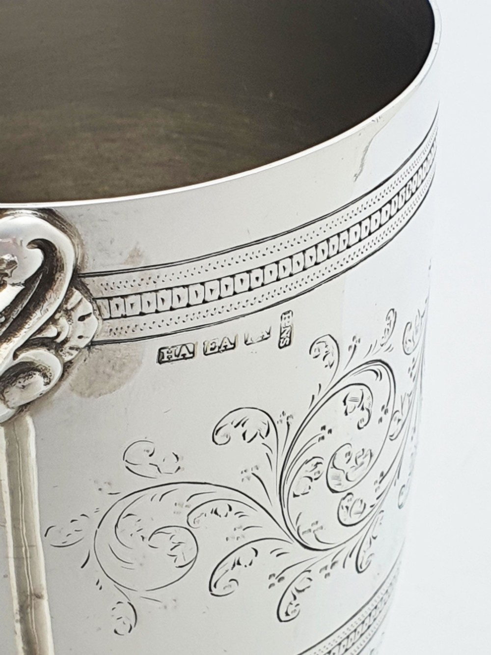An Edwardian silver-plated tankard with intricate foliate engraving, a fluted pedestal base, and a decorative handle sculpted with an owl motif. View VII