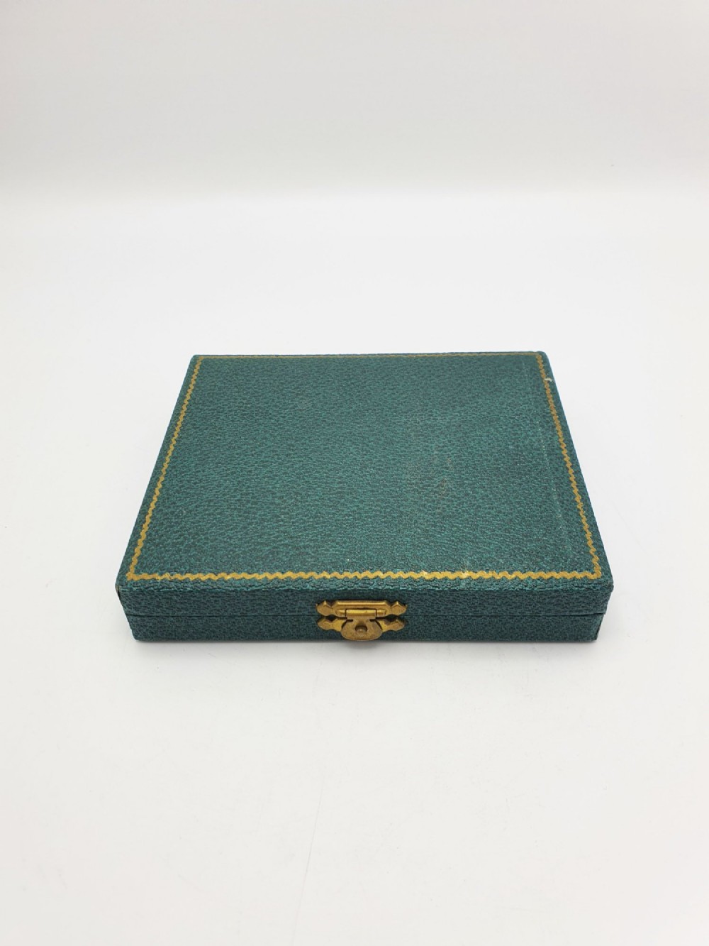 A set of six silver cocktail sticks featuring colourful enamelled cockerel finials arranged inside a dark green presentation box. View VIII