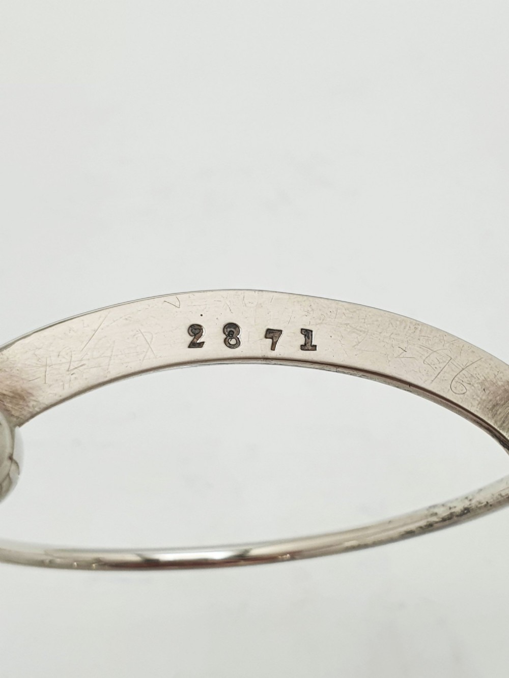 A small late Victorian sterling silver toast rack featuring five arched divisions, a central ring handle, and four ball feet. View VII