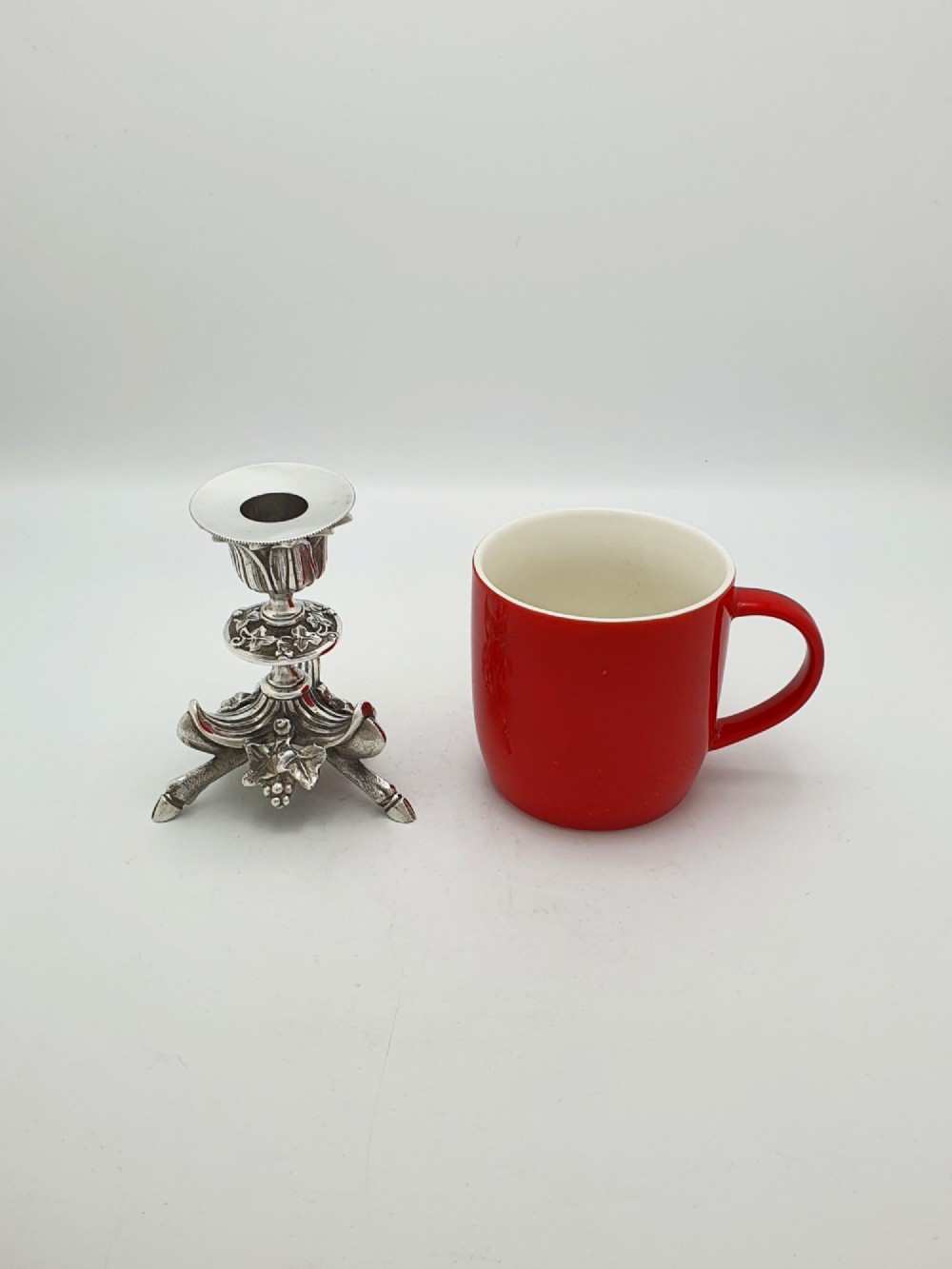 A pair of Victorian silver-plated candlesticks featuring fluted holders, grape leaf ornamentation, and tripod bases shaped like animal hooves. View VIII