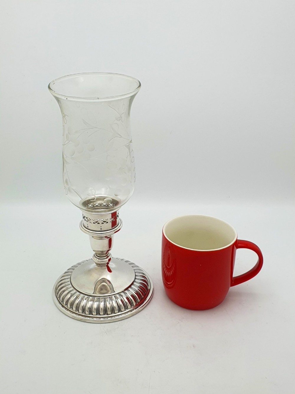 A pair of silver-plated candle holders featuring gadrooned bases and pierced sockets topped with etched glass hurricane shades. View XI