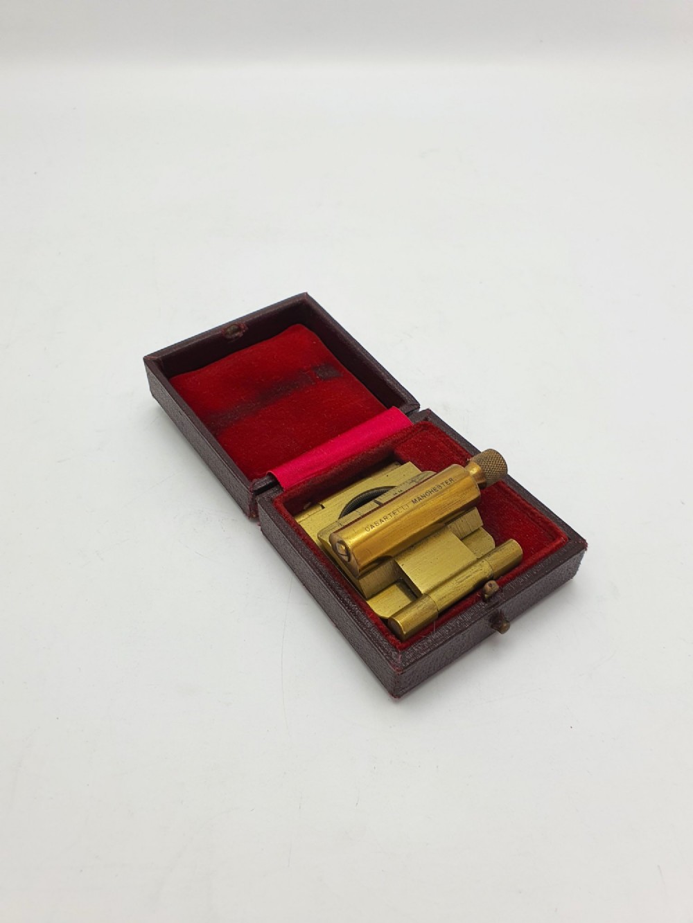 A vintage Edwardian folding brass linen tester loupe with a glass lens and measuring scale engraved on the base plate. View II
