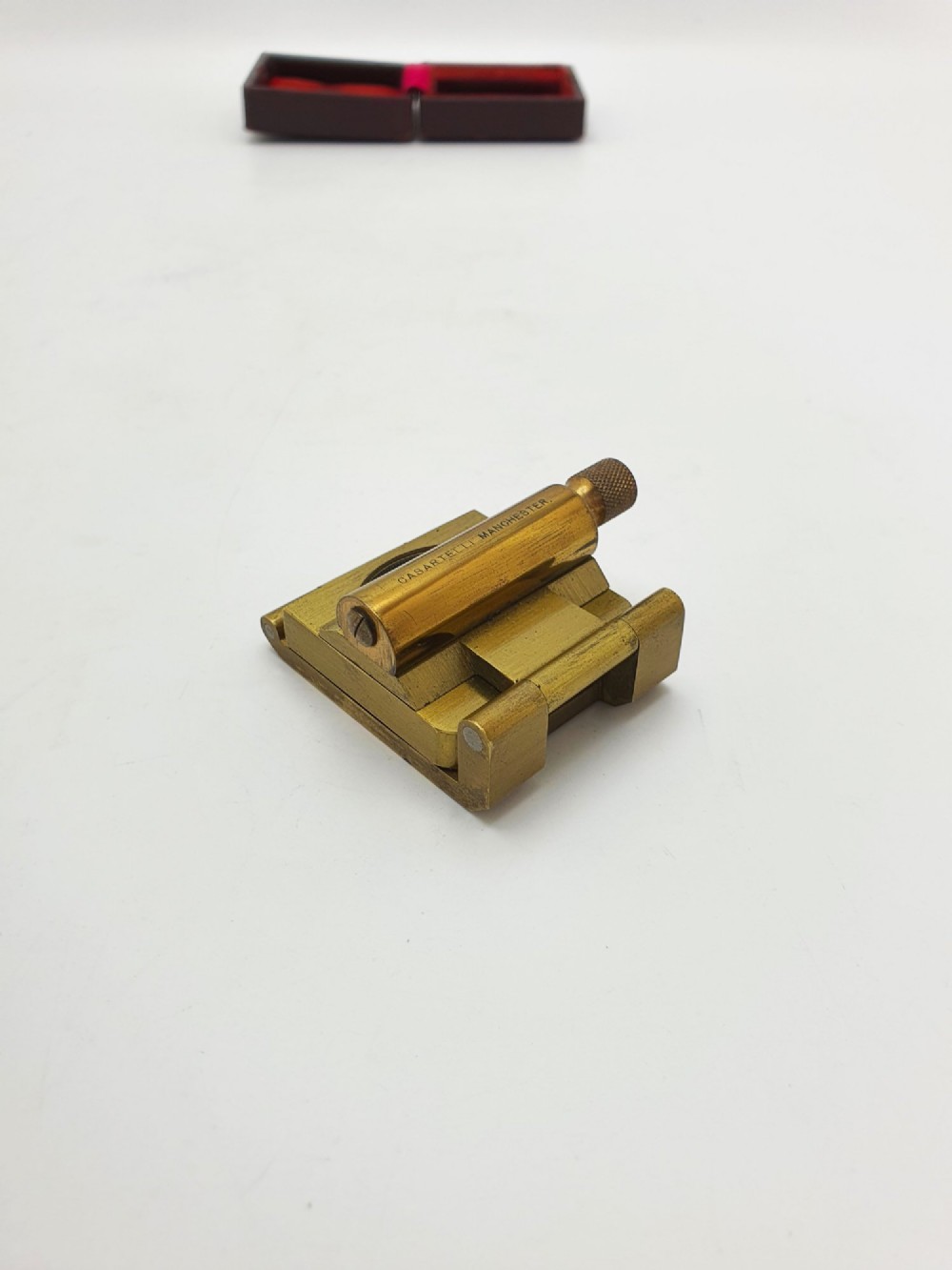 A vintage Edwardian folding brass linen tester loupe with a glass lens and measuring scale engraved on the base plate. View XII