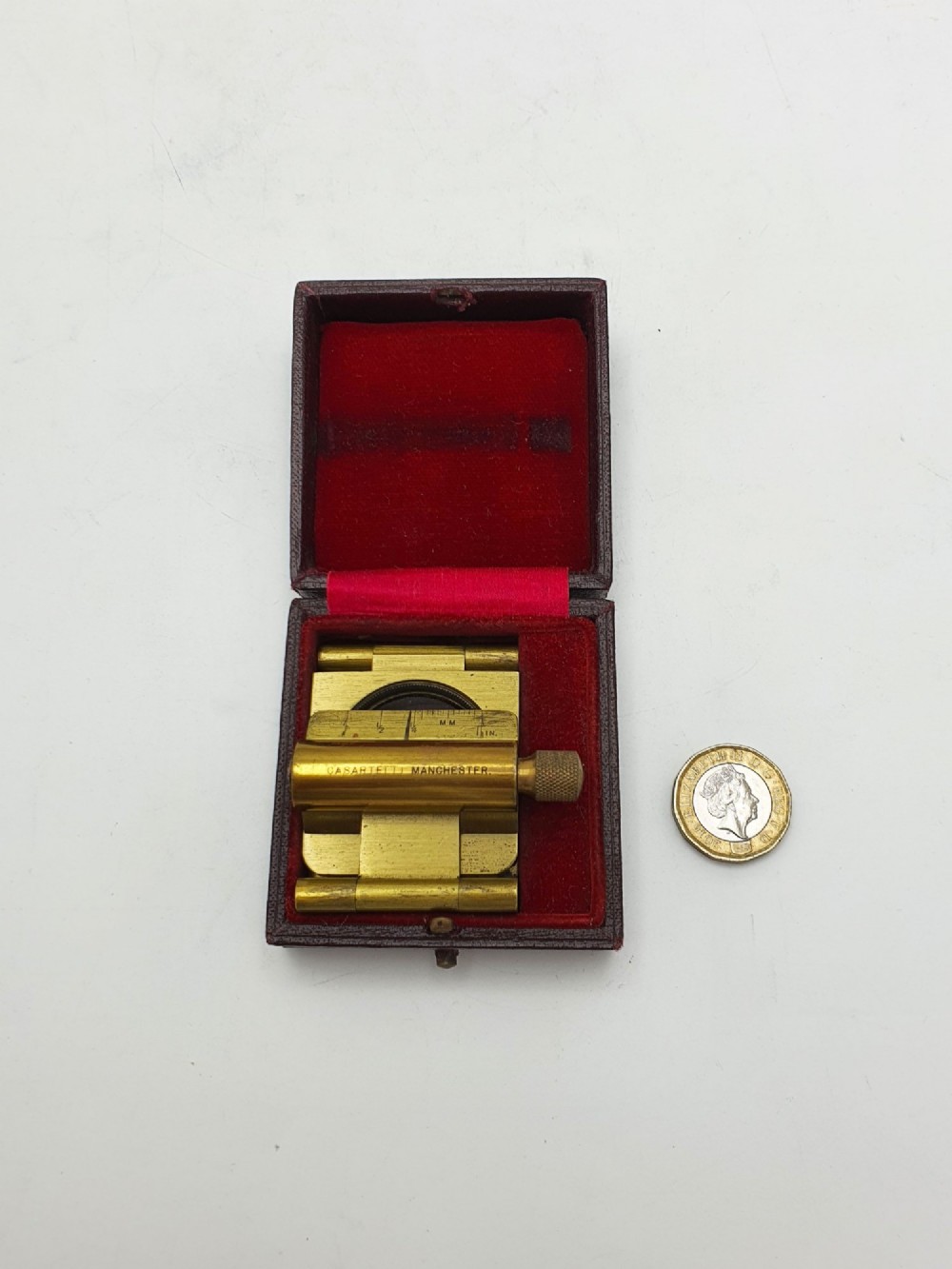 A vintage Edwardian folding brass linen tester loupe with a glass lens and measuring scale engraved on the base plate. View XIII