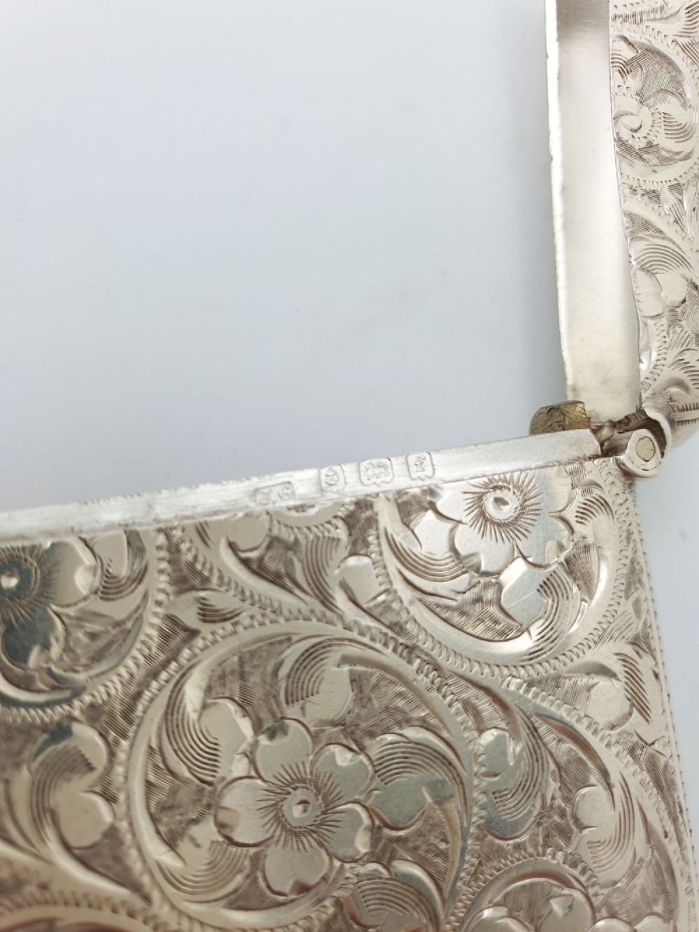 An open Edwardian sterling silver vesta case displaying an engraved hinged lid and two interior oval photo frame apertures. View VIII