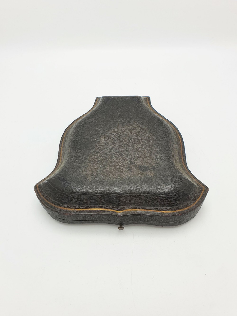 A Victorian sterling silver scallop shell butter dish and matching engraved spreader knife resting inside a fitted red and black velvet presentation case. View VI