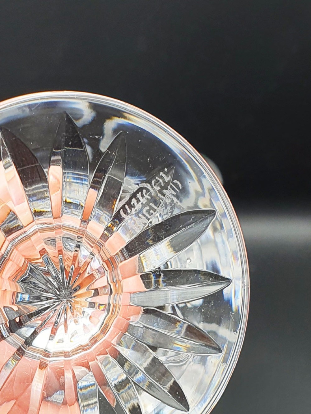 A set of eight clear cut glass wine glasses featuring faceted bowls and starburst pattern bases. View IV